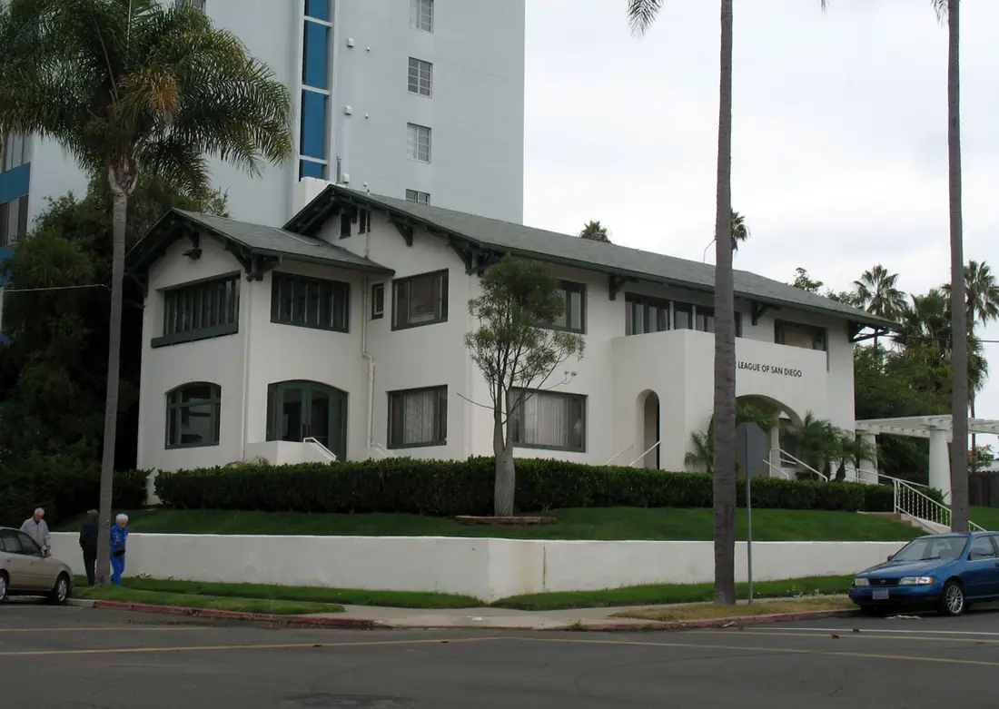 A two-story Craftsman-style building housing the League of Women Voters of San Diego, with two pedestrians on the sidewalk in front.