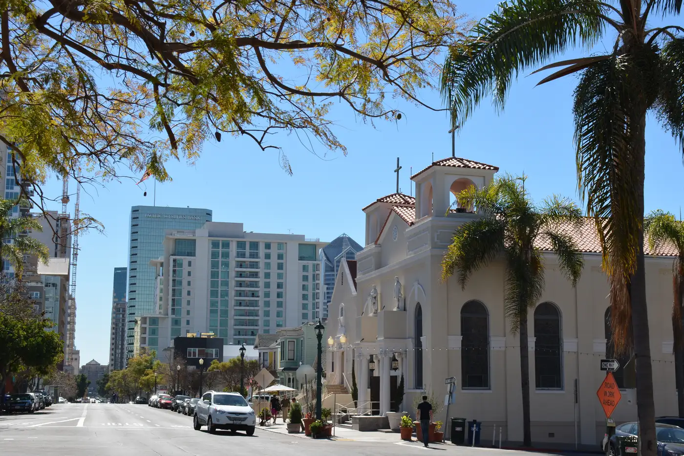Our Lady of the Rosary Church on India Street in Little Italy, with the downtown San Diego skyline rising behind it.