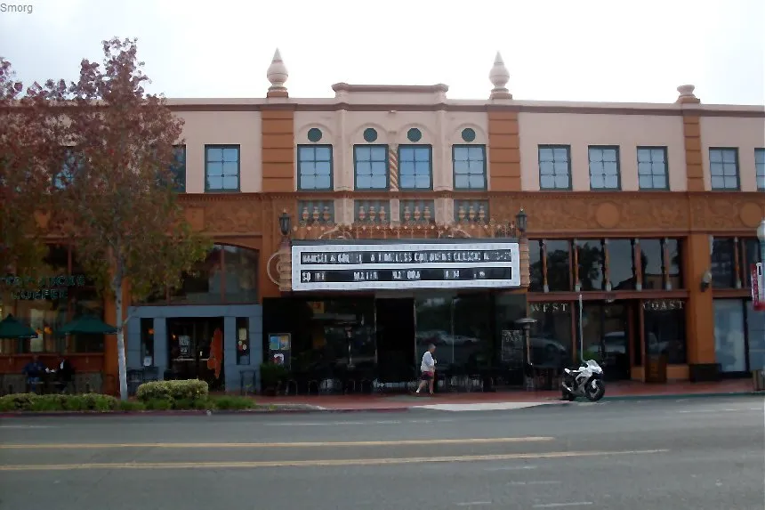 The historic Birch North Park Theater marquee and ornate two-story facade on University Avenue, with a motorcycle parked at the curb.